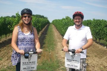 Couple on segways in vineyard
